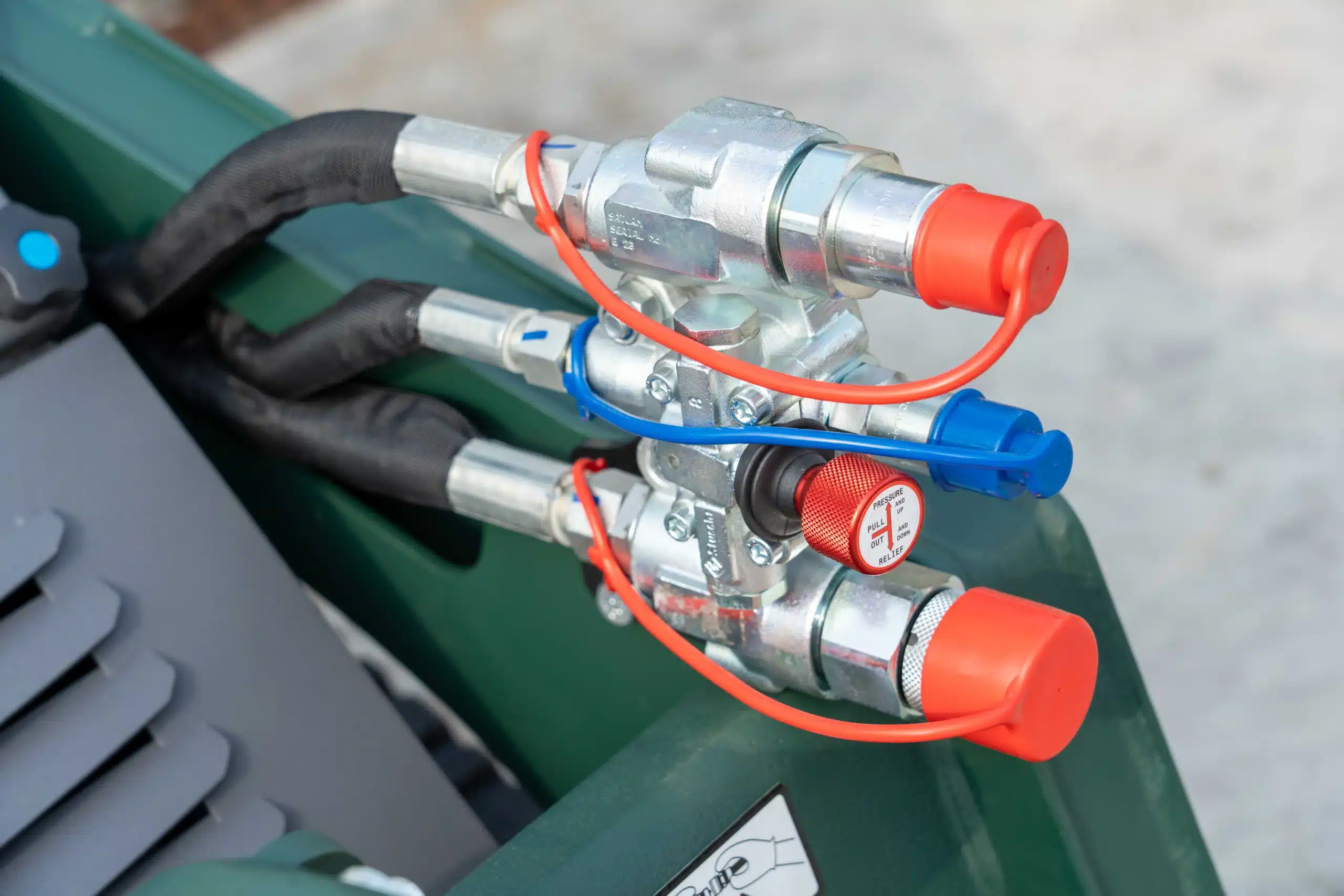 Close up of the high and low flow hydraulic ports on the SAM-1200Z for versatile attachment use.