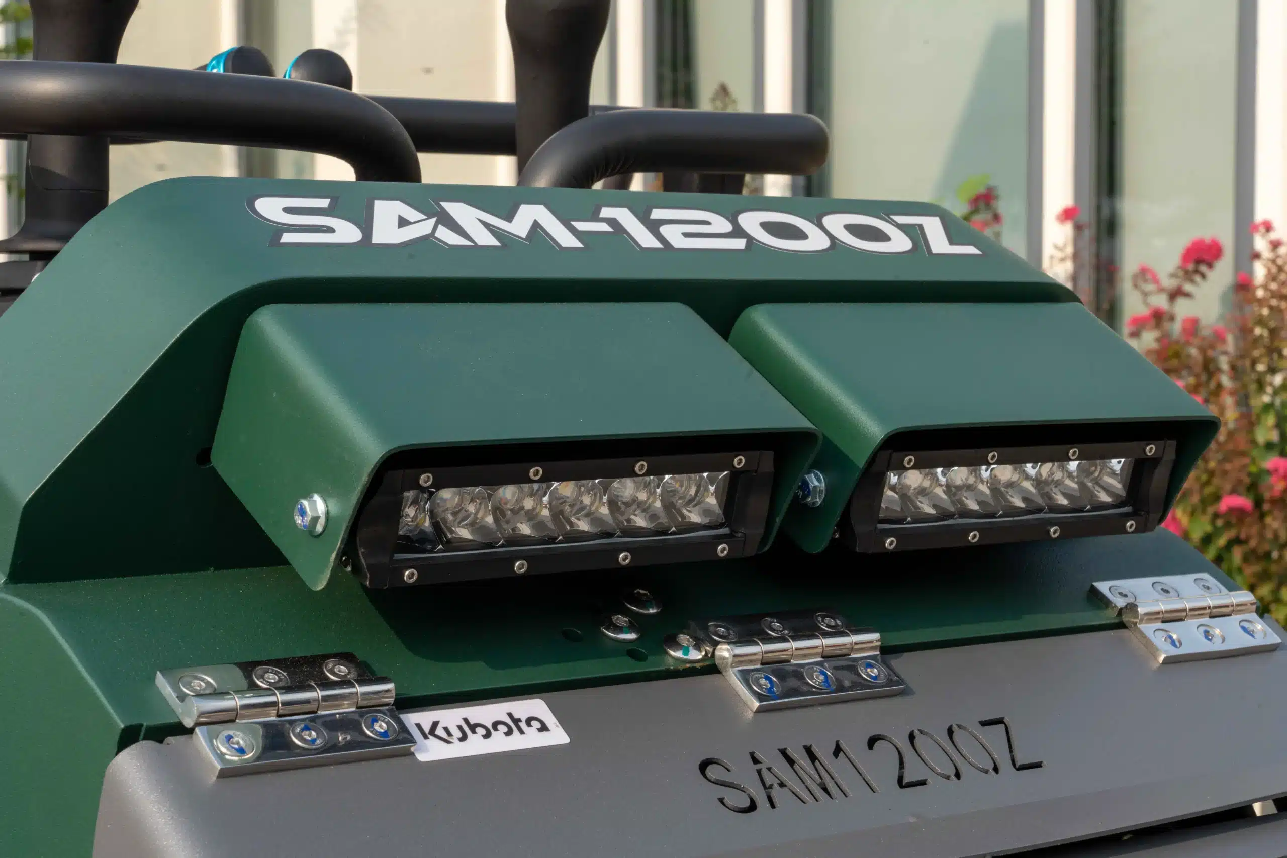 Protective engine cover and front work lights that safeguard the Kubota D1703-M diesel engine.