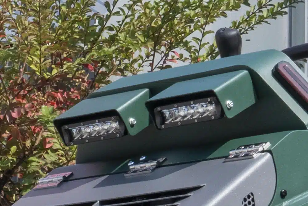 High-visibility front work lights and reinforced front panel for safe operation in low-light commercial environments.