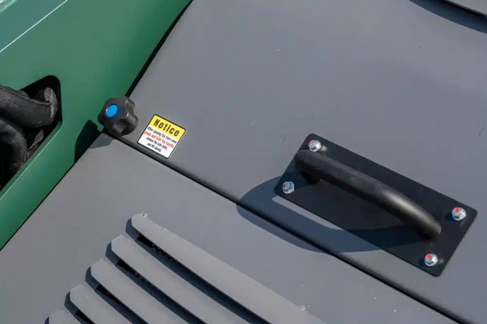 Rugged steel engine cover on the SAM-1950Z designed for easy access and protection of the Yanmar diesel engine.